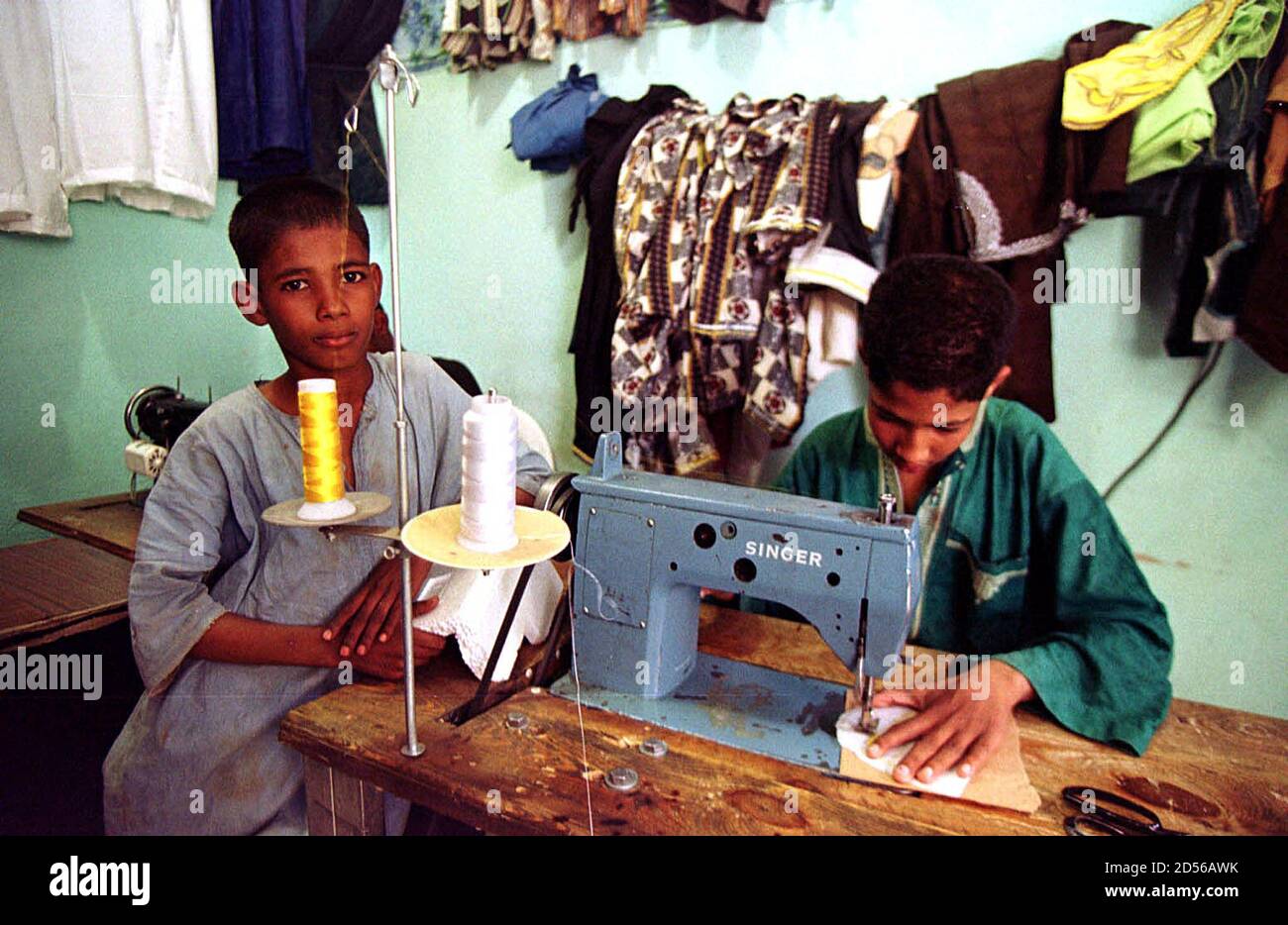 Fares A 13 Year Old Algerian Boy R Is Accompanied By An Unidentified Friend As He Works At A Sewing Machine In The Family Tailors Shop In The Town Of Tamanrasset April Fares A 13 Year Old Algerian Boy R Is Accompanied By An Unidentified Friend As He Works At A Sewing Machine In The Family Tailors Shop In The Town Of Tamanrasset April