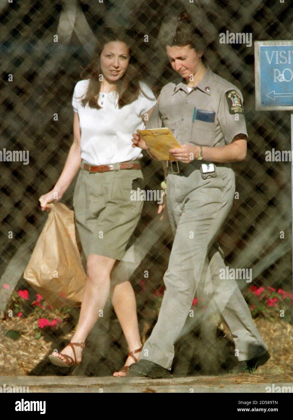 Amy Fisher walks from her dormatory at the Albion Women's Correctional  Facility with an unidentified prison guard May 10 as she reports to the  out-processing center. Fisher, nicknamed the notorious "Long Island