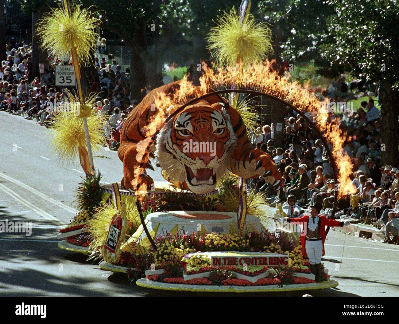 A huge tiger appears to be frozen in midair as she leaps towards a ring of  fire on the Reser's Fine Foods float as it appears in the 109th annual  Tournament of