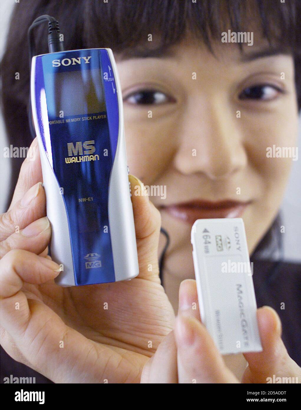 Sony Marketing's Fumie Kagaya shows off a "Memory Stick Walkman" portable audio player and "MagicGate Memory IC recording media at a Sony office in Tokyo September 28. Sony Corporation announced plans