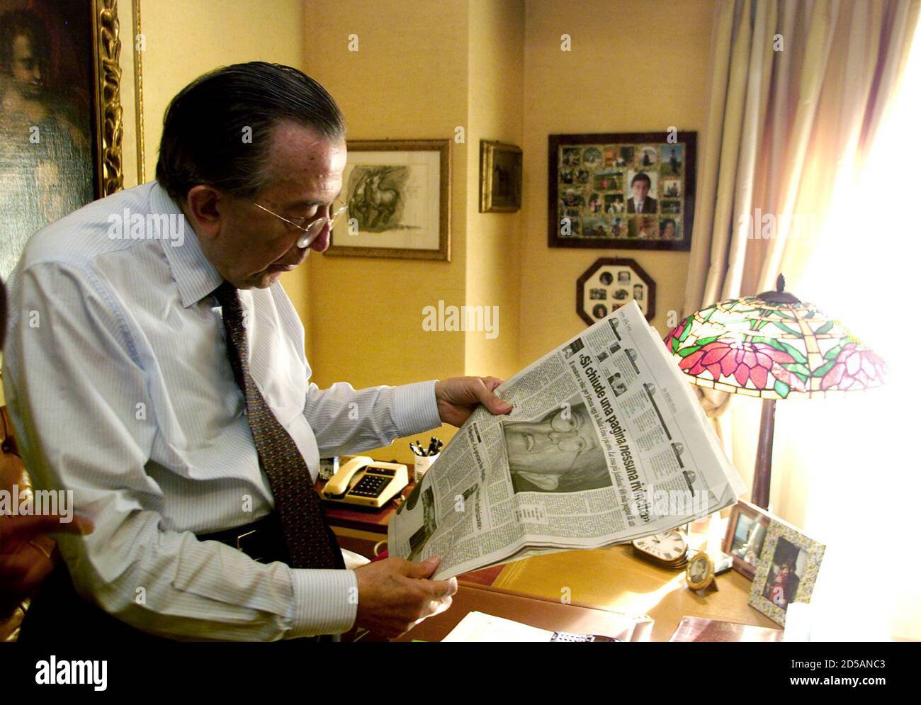 Seven-times Italian prime minister Giulio Andreotti reads a newspaper with  a picture of himself on the cover,in his office September 25. Andreotti was  acquitted on September 24 of ordering the murder of