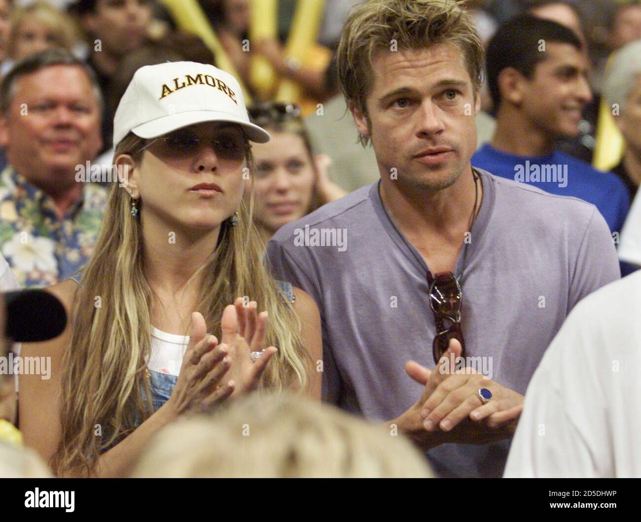 Actor Brad Pitt (R) and girlfriend Jennifer Aniston, star of the television  comedy series " Friends" watch Game 6 of the NBA Finals at the Staples  Center in Los Angeles, June 19. [