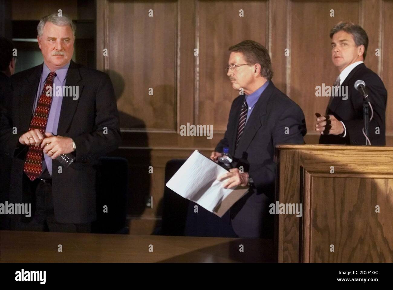 Boulder County District Attorney Alex Hunter (C) leaves a press conference  with Adams County District Attorney Bob Grant (L) and special prosecutor  Michael Morrissey after they spoke about the JonBenet Ramsey case