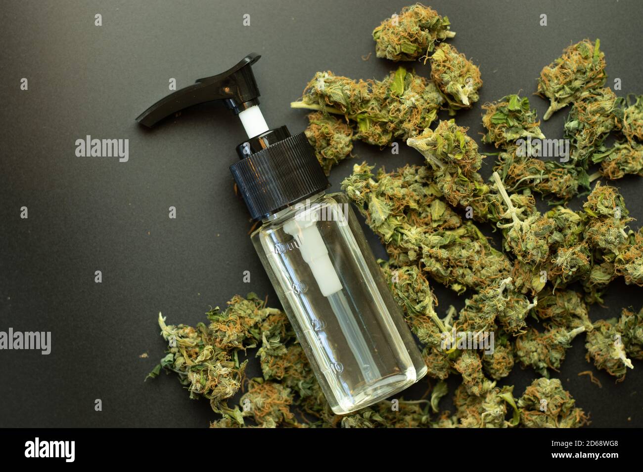 THC o CBD petróleo vista superior sobre el fondo del cannabis, brotes de marihuana de cerca. Uso de malezas médicas Foto de stock