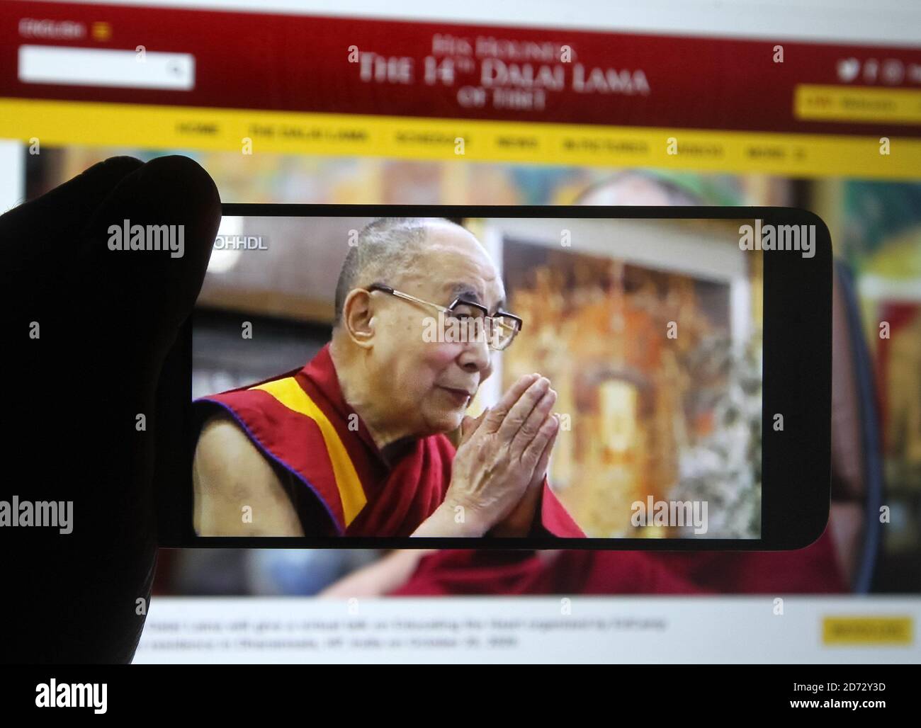 En esta ilustración de la foto, el líder espiritual tibetano el Dalai Lama  es visto en una pantalla de teléfono móvil durante un webcast en vivo de su  programa de charla sobre