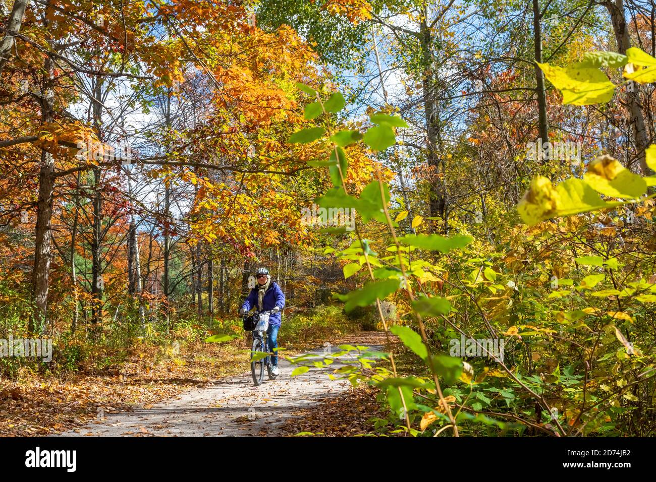 Avoca, Michigan - Susan Newell, 71, bicicletas en el camino de Wadhams a Avoca Trail. El sendero de 12 millas fue creado a partir de una antigua línea de ferrocarril CSX. Foto de stock