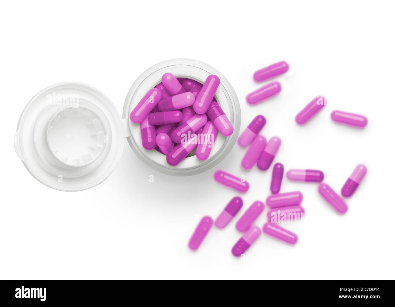 Vista superior de tubo de color rosa montón de pastillas contra fondo blanco. Enfoque en la parte superior del bote y enfoque suave en el fondo para dar profundidad a la imagen. Foto de stock