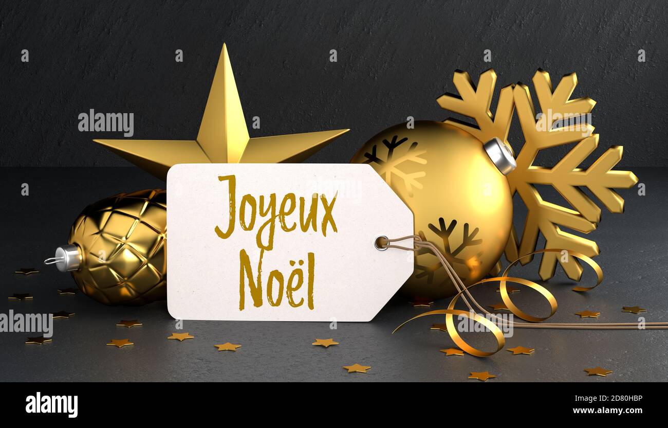 Navidad - etiqueta de regalo con el mensaje de Navidad feliz francés 'Joyeux Noel' (Feliz Navidad) sobre un fondo de piedra negra apoyado sobre el color dorado Foto de stock