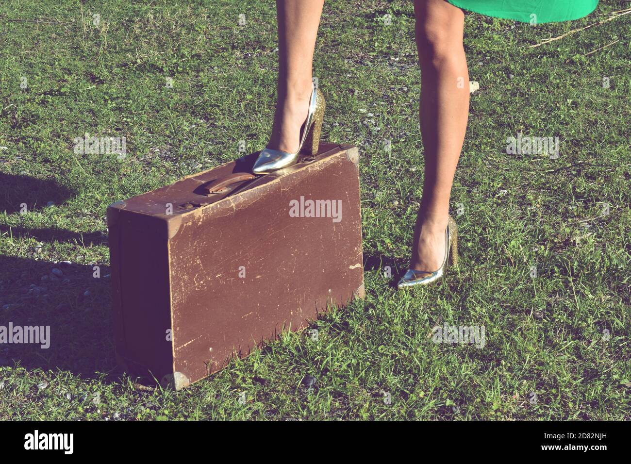 Mujer con tacones altos dorados junto al equipaje en la carretera  Fotografía de stock - Alamy