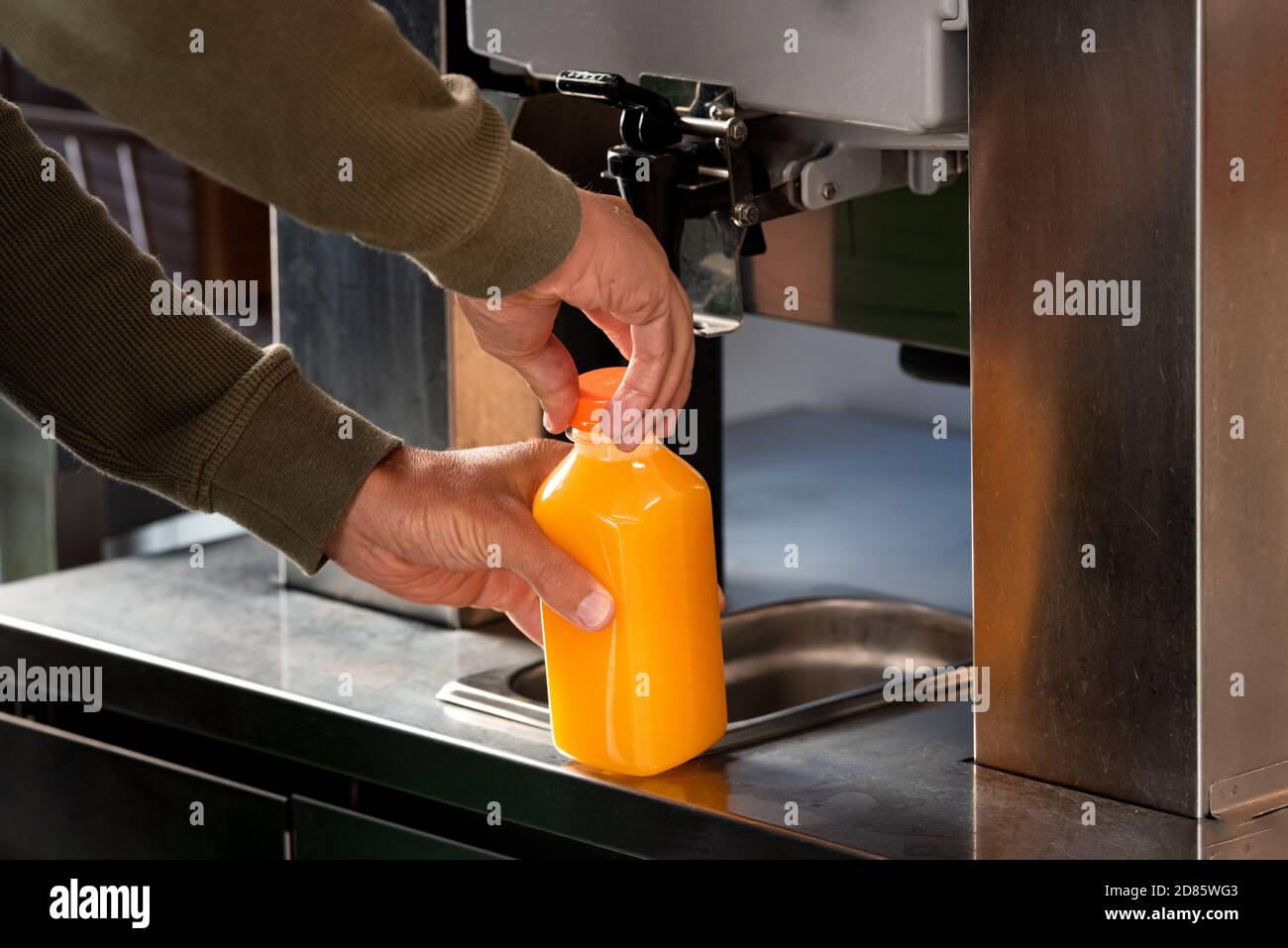 Zumo de naranja de una licuadora en el supermercado. Exprimidor de