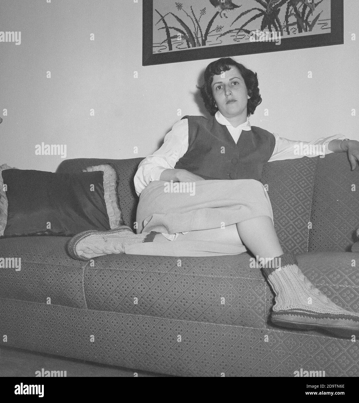 Imagen vintage de una joven que se relaja en su sofá en casa, EE.UU. 1952 Foto de stock