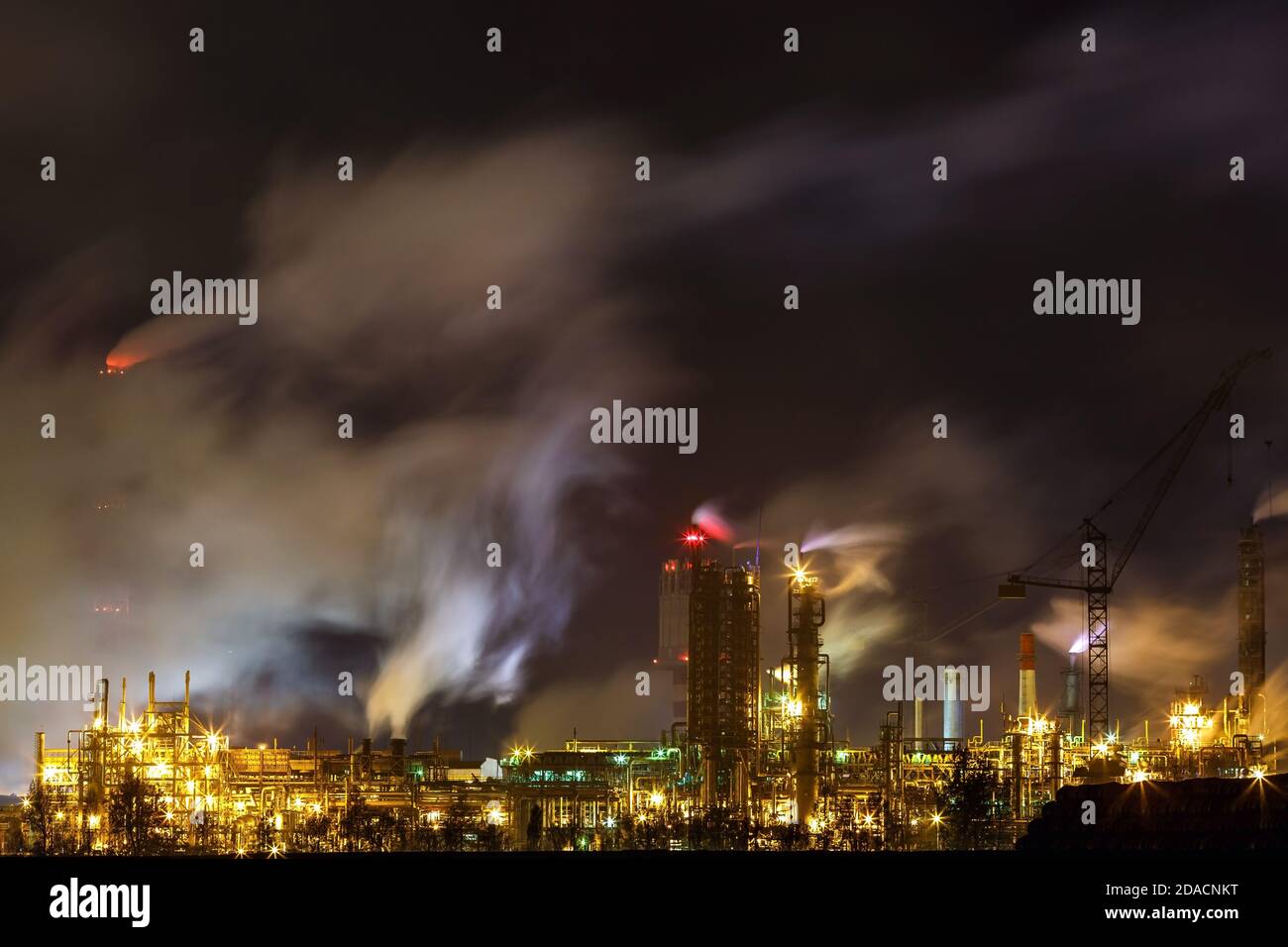 noche paisaje industrial contaminación ambiental residuos de la central  térmica. Grandes tuberías de la planta de la industria química Fotografía  de stock - Alamy