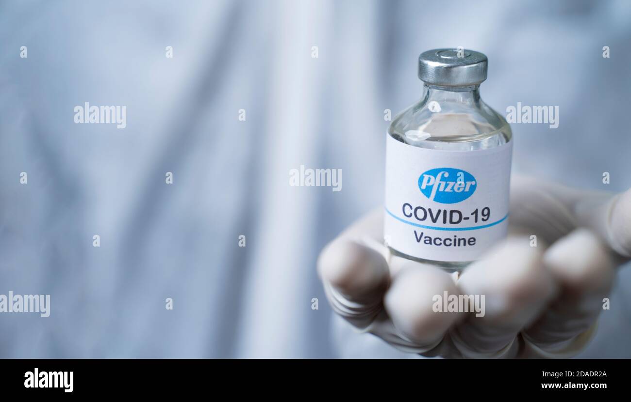 Maski, India - Nov 12,2020 : cerca de manos del médico que le dan la vacuna Pfizer BioNTech para proteger contra el coronavirus o la pandemia de covid-19. Foto de stock