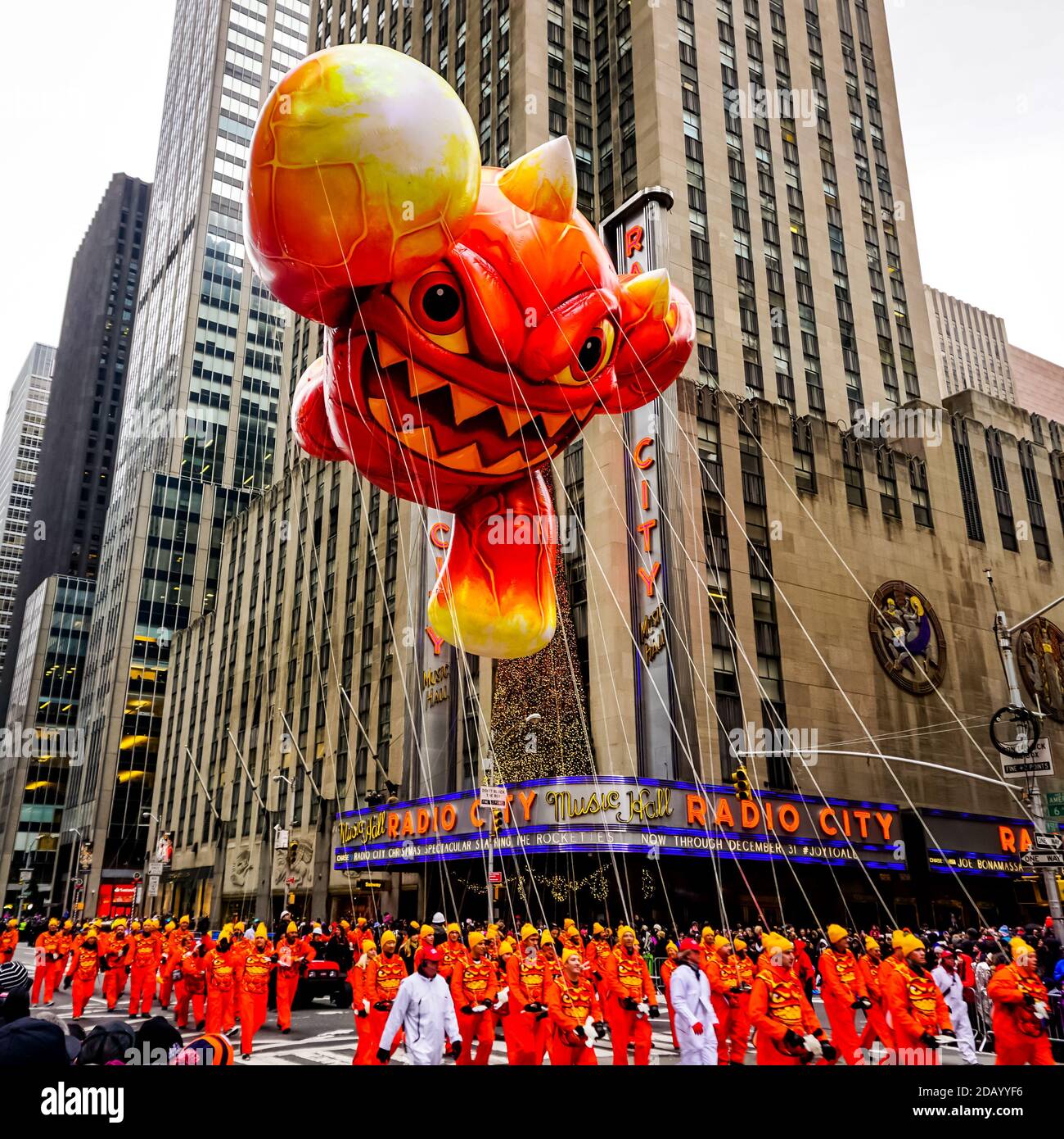 El globo de Skylander Eruptor flota en el aire durante el día de Acción de Gracias de Macy Desfile de día a lo largo de la Avenida de las Américas con la Radio Música Hall en el fondo Foto de stock