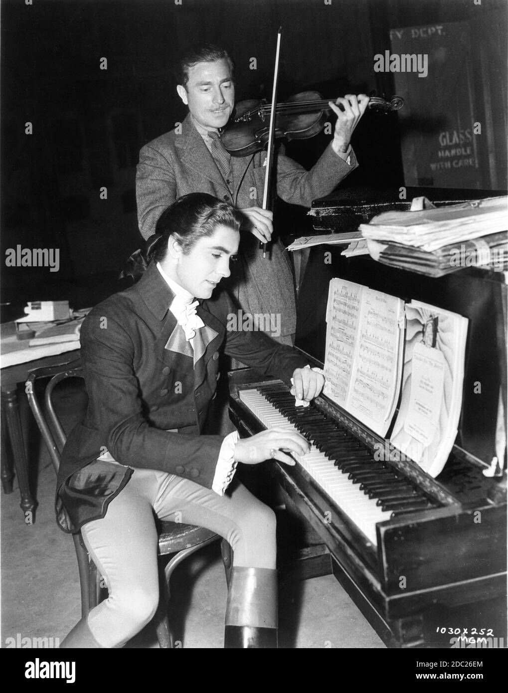TYRONE POWER toca piano en conjunto con acompañamiento del violinista de música  ambiental SIGMUND SAXS de Norma Shearer durante el rodaje de LA directora  W.S. DE MARIE ANTOINETTE 1938 Van DYKE Metro