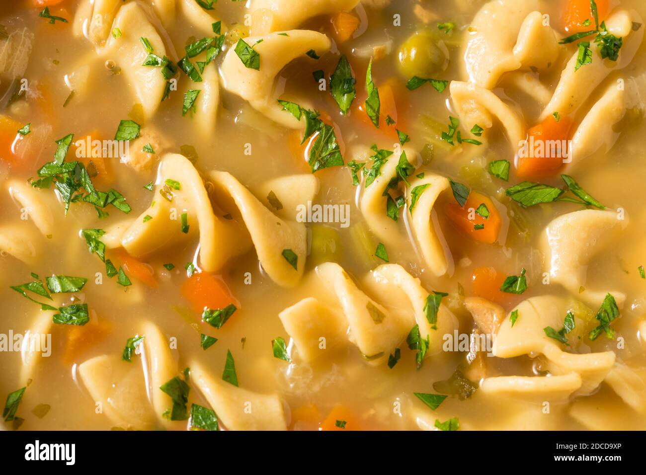 Sopa casera de fideos de pollo con guisantes y zanahorias Fotografía de stock - Alamy Sopa casera de fideos de pollo con guisantes y zanahorias Fotografía de stock - Alamy