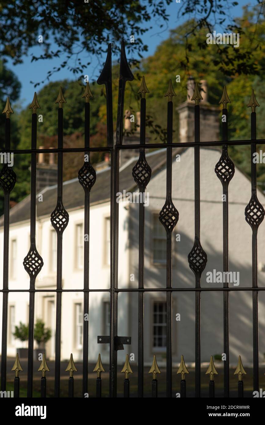 Puerta de hierro forjado con una elegante mansión en el Antecedentes en Escocia Foto de stock