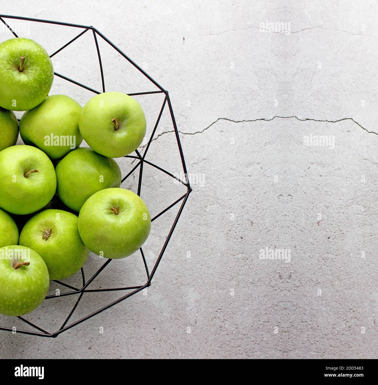 Frutos verdes maduros de manzana sobre mesa de piedra. Vista superior con espacio de copia. Lay plano. Foto de stock