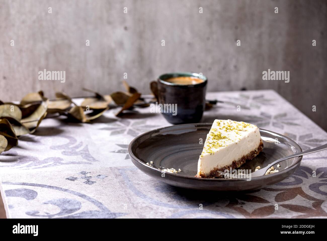 Tarta de queso vegano cruda con ralladura de lima y nueces de anacardo placa Foto de stock