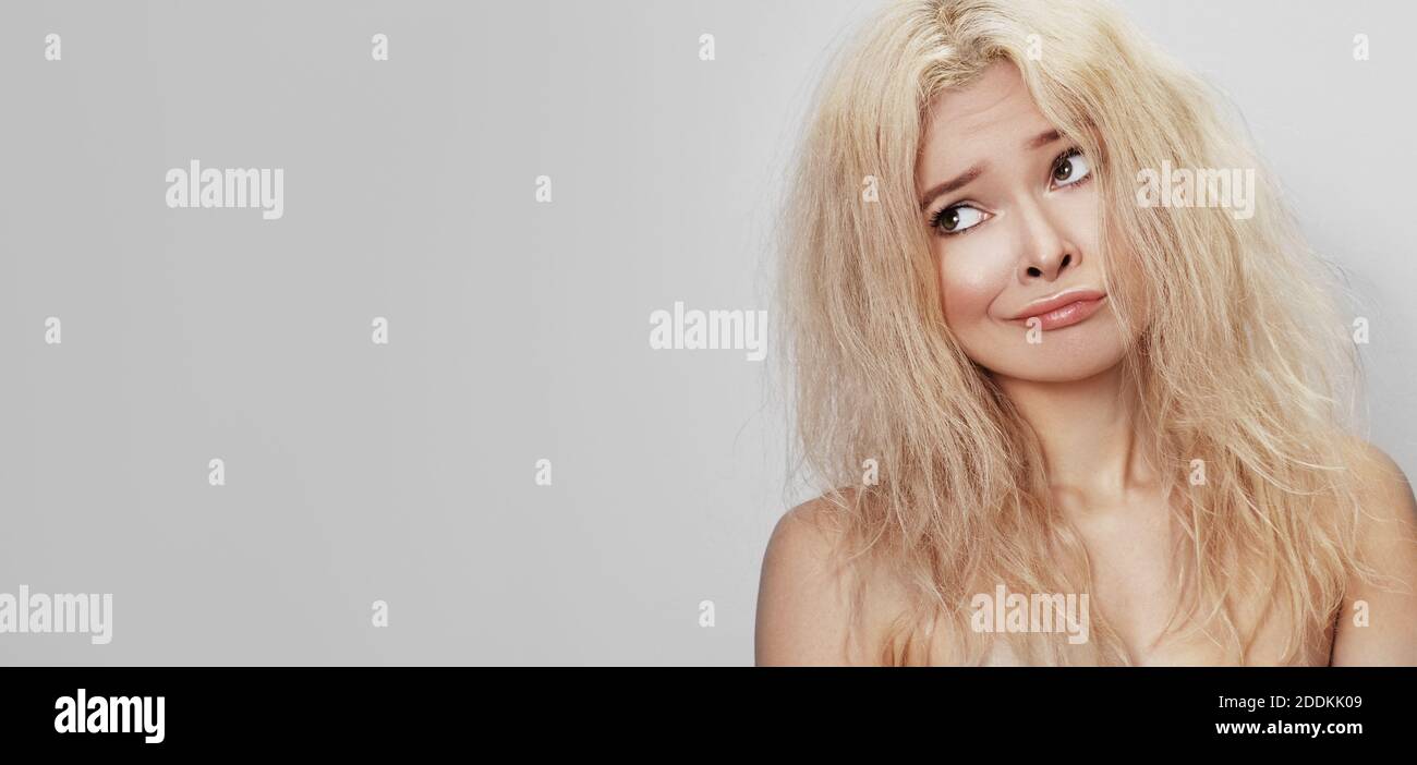 Mal pelo día. Hermosa mujer con el cabello desordenado. Cara triste  infeliz. Blanquimiento rubio peinado con problema cabello quebradizo  Fotografía de stock - Alamy