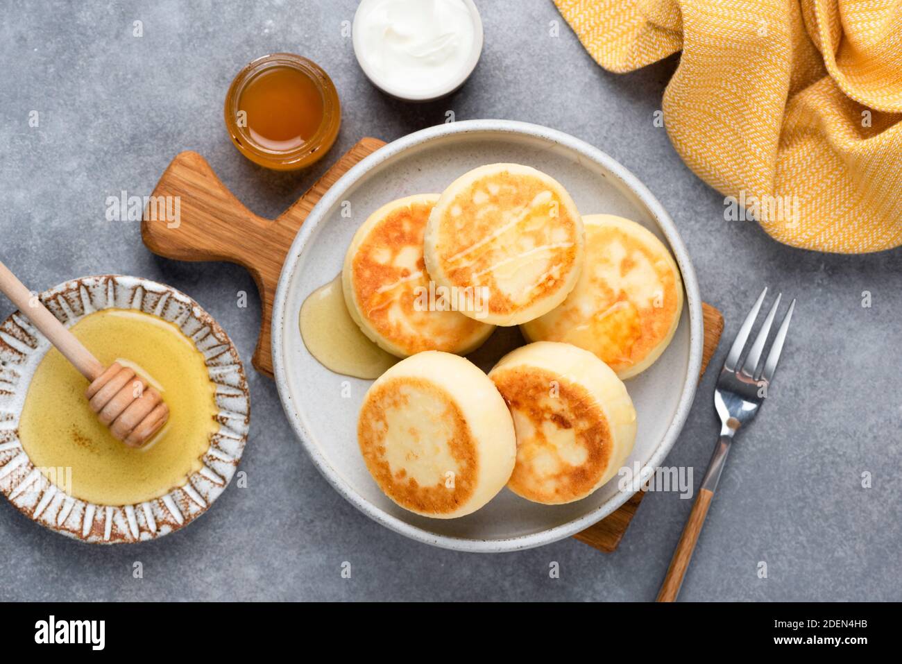 Sabrosas frituras de queso de la cabaña Sirniki servido con miel. Vista superior. Comida rusa, ucraniana Foto de stock