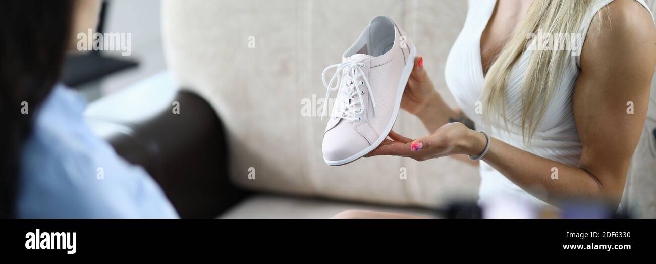 La mujer demuestra zapatos y hace una revisión en video Fotografía de stock  - Alamy