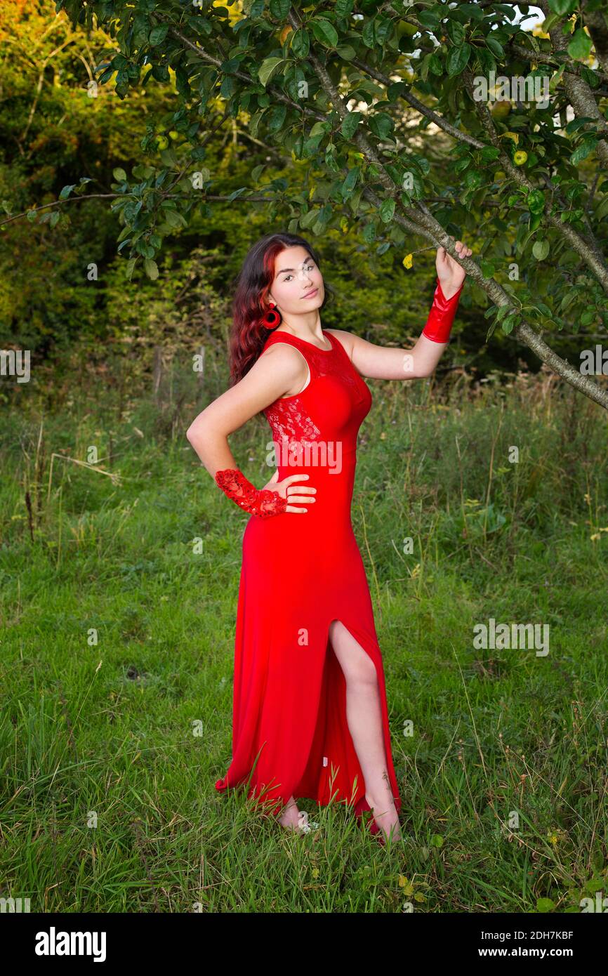 Una hermosa adolescente con un vestido rojo el campo Foto de stock