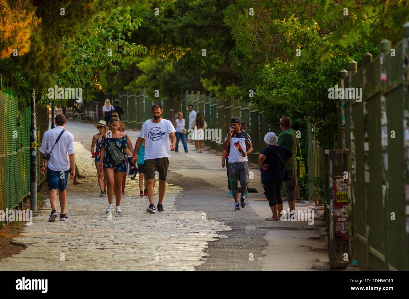 Los turistas caminan por debajo de la antigua Acrópolis en la zona de Plaka en el centro de Atenas Grecia - Foto: Geopix Foto de stock