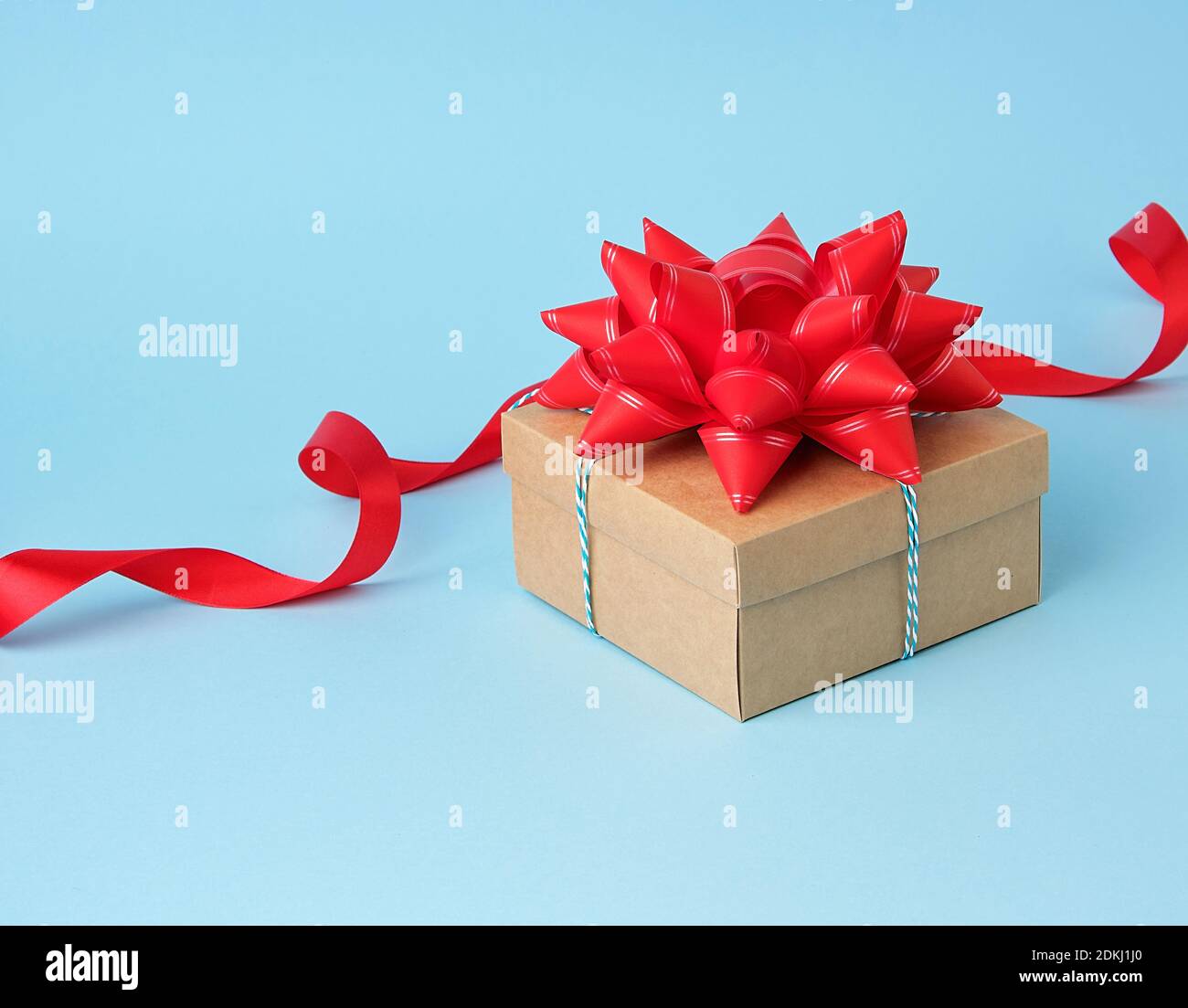 Cerrado de regalo de cartón azul caja cuadrada atado tropo blanca sobre  fondo azul, vista superior, fondo de vacaciones Fotografía de stock - Alamy