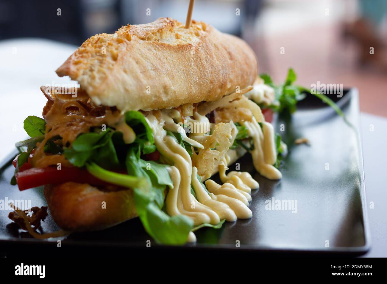 Gran sándwich de pollo en pan francés baguette con verduras, cebolla