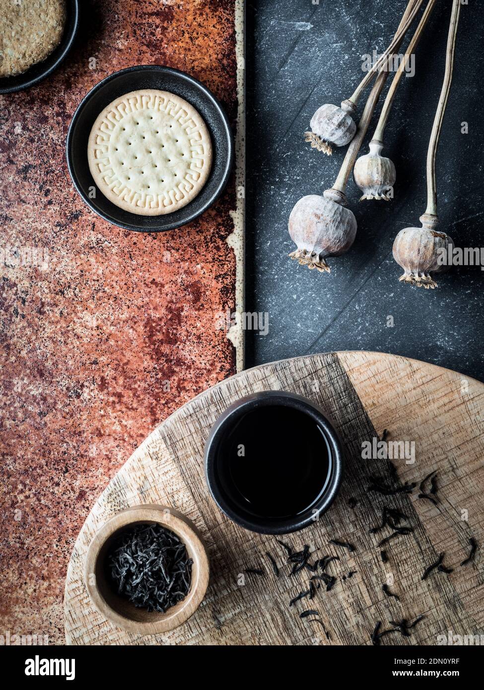 Different types of cookies and cup of cofee on grey and teracota background. Overhead shot. Foto de stock