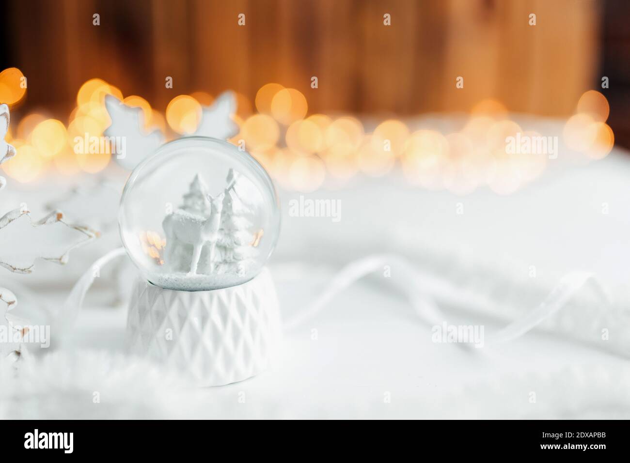 Blanco bola de nieve de Navidad en una mesa con decoraciones de Navidad Foto de stock