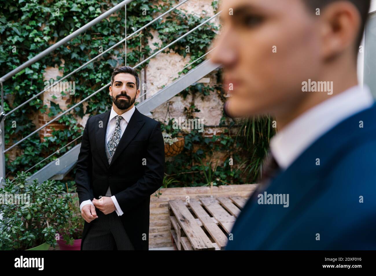 Jóvenes vestidos bien en el jardín el día de la boda Foto de stock