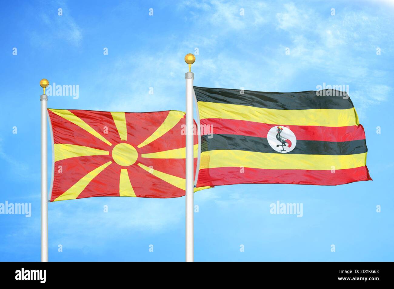 Norte de Macedonia y Uganda dos banderas en los polos de bandera y azul cielo Foto de stock