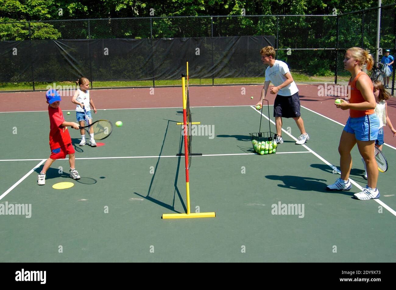 Omitido llamada ensayo Niños pequeños tomando clases de tenis proporcionadas por un municipio  local para ayudar a los niños a retardar el juego de tenis Fotografía de  stock - Alamy