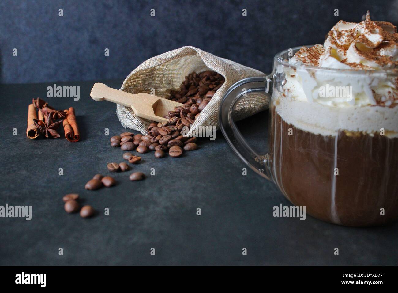 bebida de café espumosa. Cappuccino o latte en un cristal transparente sobre fondo oscuro Foto de stock