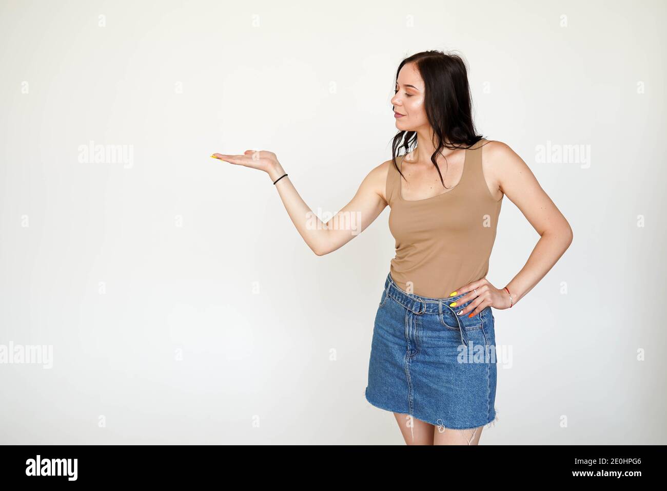 mujer en falda azul presentándose. aislada sobre fondo blanco con espacio de copia Foto de stock