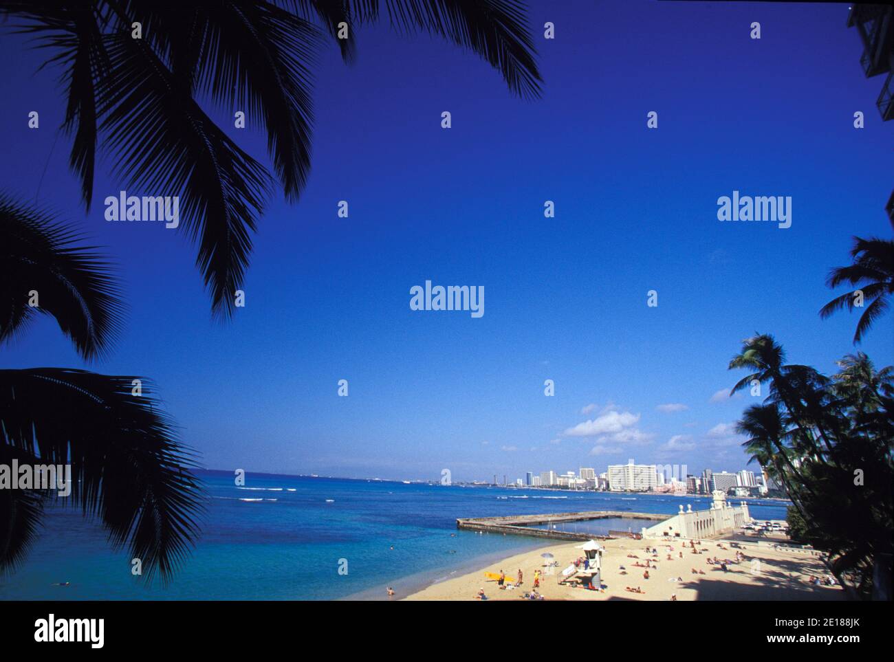 View of Waikiki from New Otani Hotel, showing Queens Beach, Natatorium and hotels in background Foto de stock