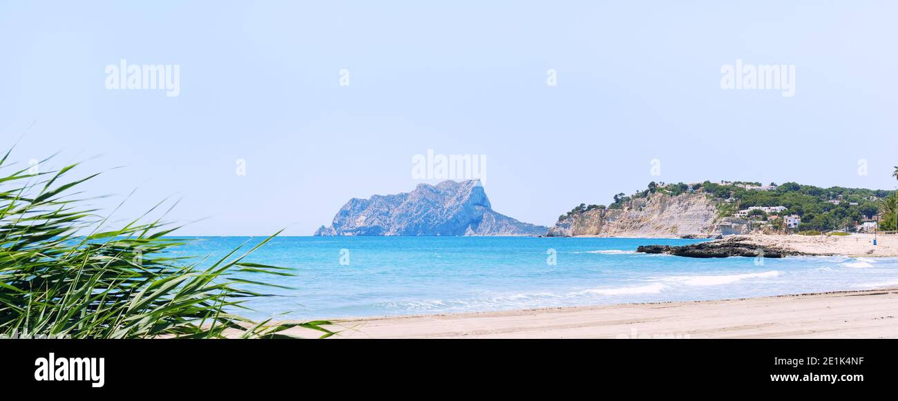 Vista horizontal panorámica playa de arena vacía de Moraira durante el soleado día de verano, ciudad costera española. Alicante, Costa Blanca, España Foto de stock