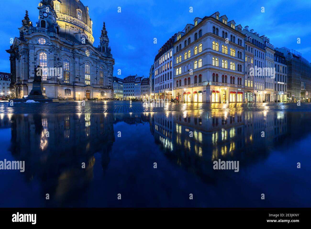 Dresde, Alemania. 19 de enero de 2021. La Frauenkirche (l) y las casas de la Neumarkt se reflejan en un banco de piedra húmeda a última hora de la tarde. Crédito: Robert Michael/dpa-Zentralbild/dpa/Alamy Live News Foto de stock