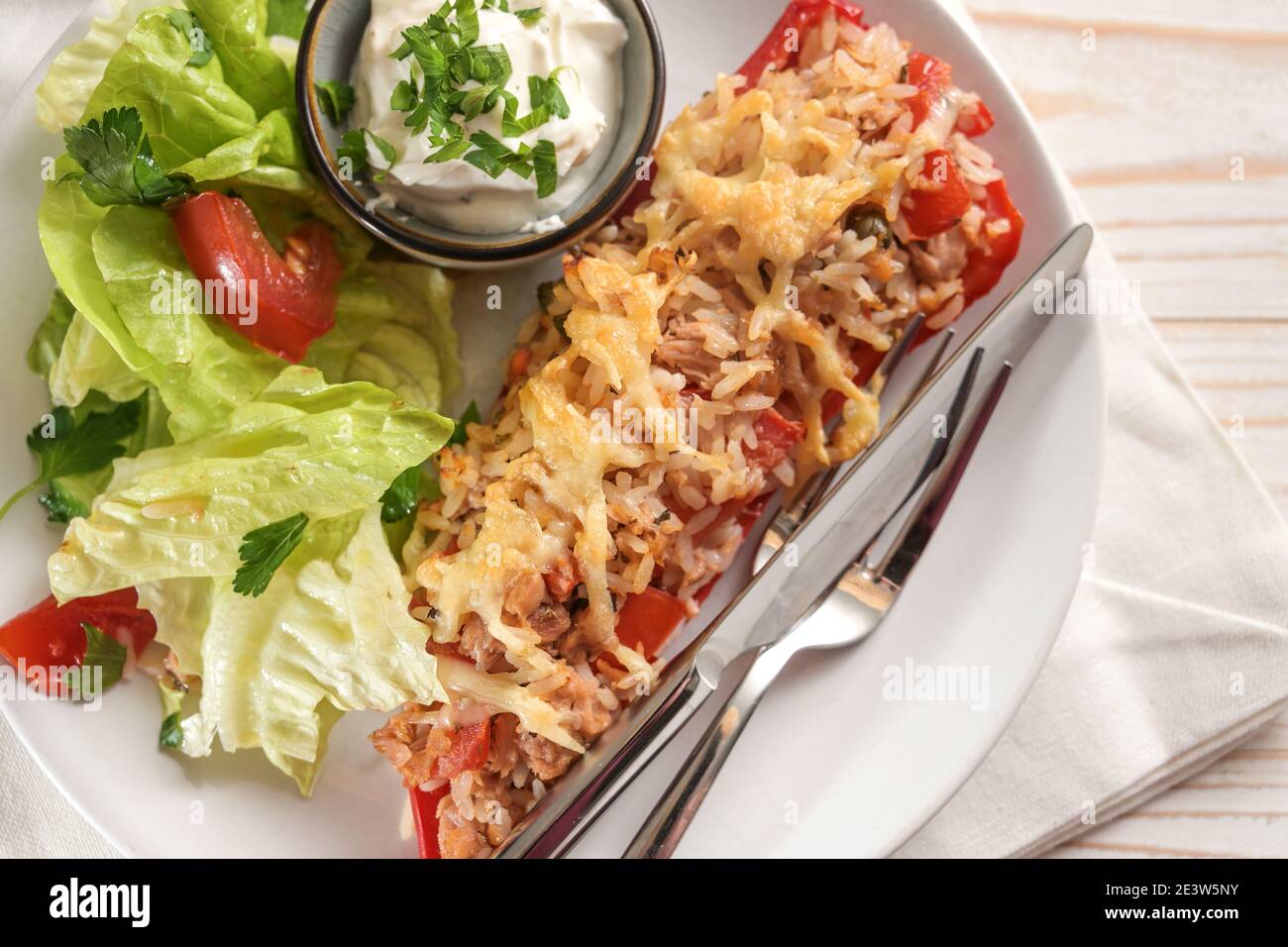 Pimiento puntiagudo al horno relleno de arroz, atún, tomates y queso en un  plato blanco con ensalada de lechuga y salsa, primeros planos, vista de  ángel alto Fotografía de stock - Alamy