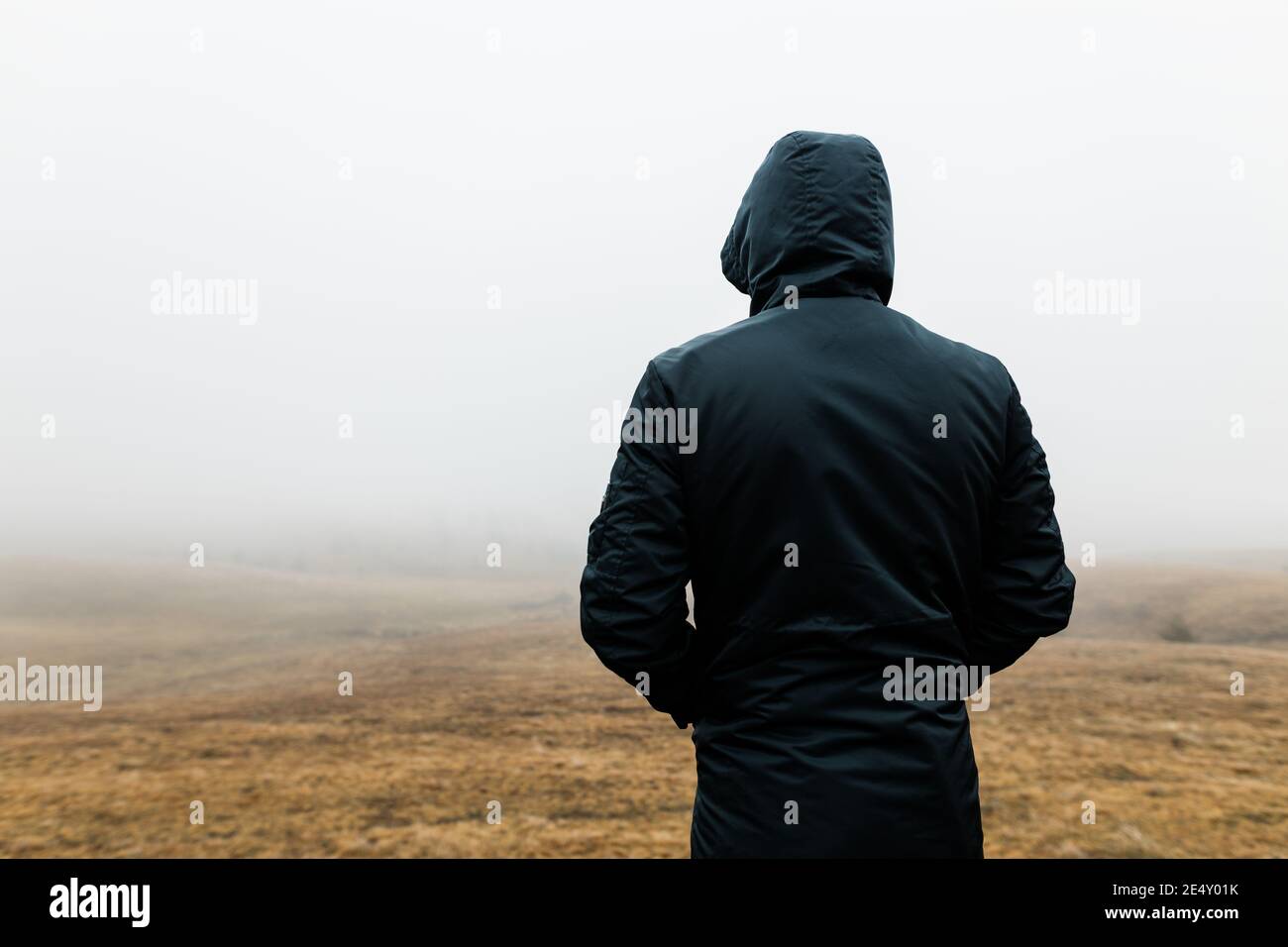 Hombre joven explorando la naturaleza en una húmeda mañana de invierno las montañas Foto de stock