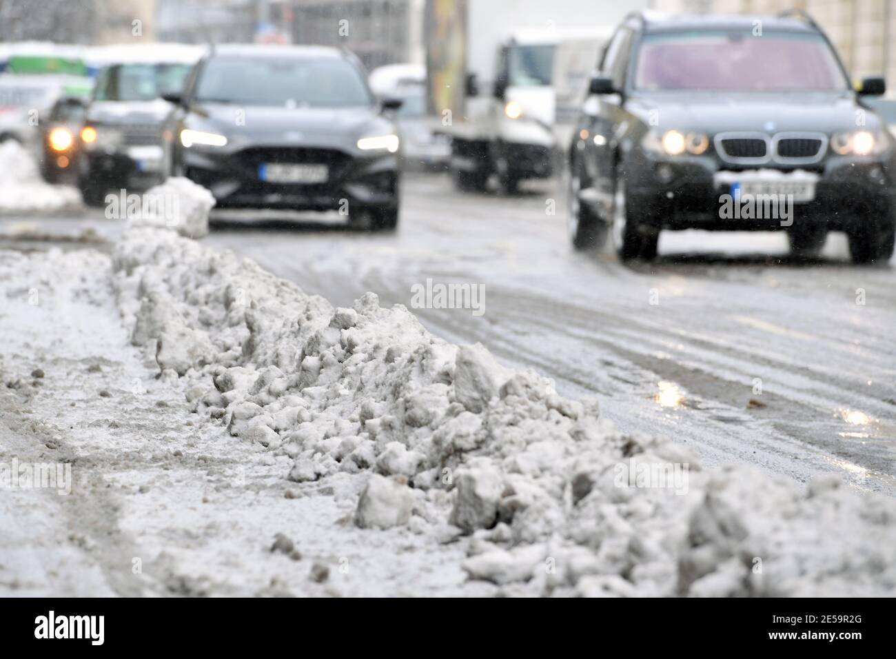 Munich, Alemania. 26 de enero de 2021. Tema de invierno en la pandemia del  coronavirus. Comienzo del invierno en los coches de Munich, los coches  conducen en la nieve despejada Von-der-Tann-Strasse en