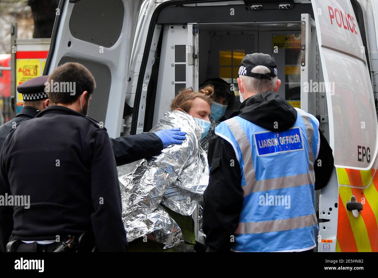 Un oficial de policía detiene a un manifestante cuando los activistas de la rebelión de extinción ocupan túneles bajo Euston Square Gardens para protestar contra el ferrocarril de alta velocidad HS2, en Londres, Gran Bretaña 28 de enero de 2021. REUTERS/Toby Melville Foto de stock