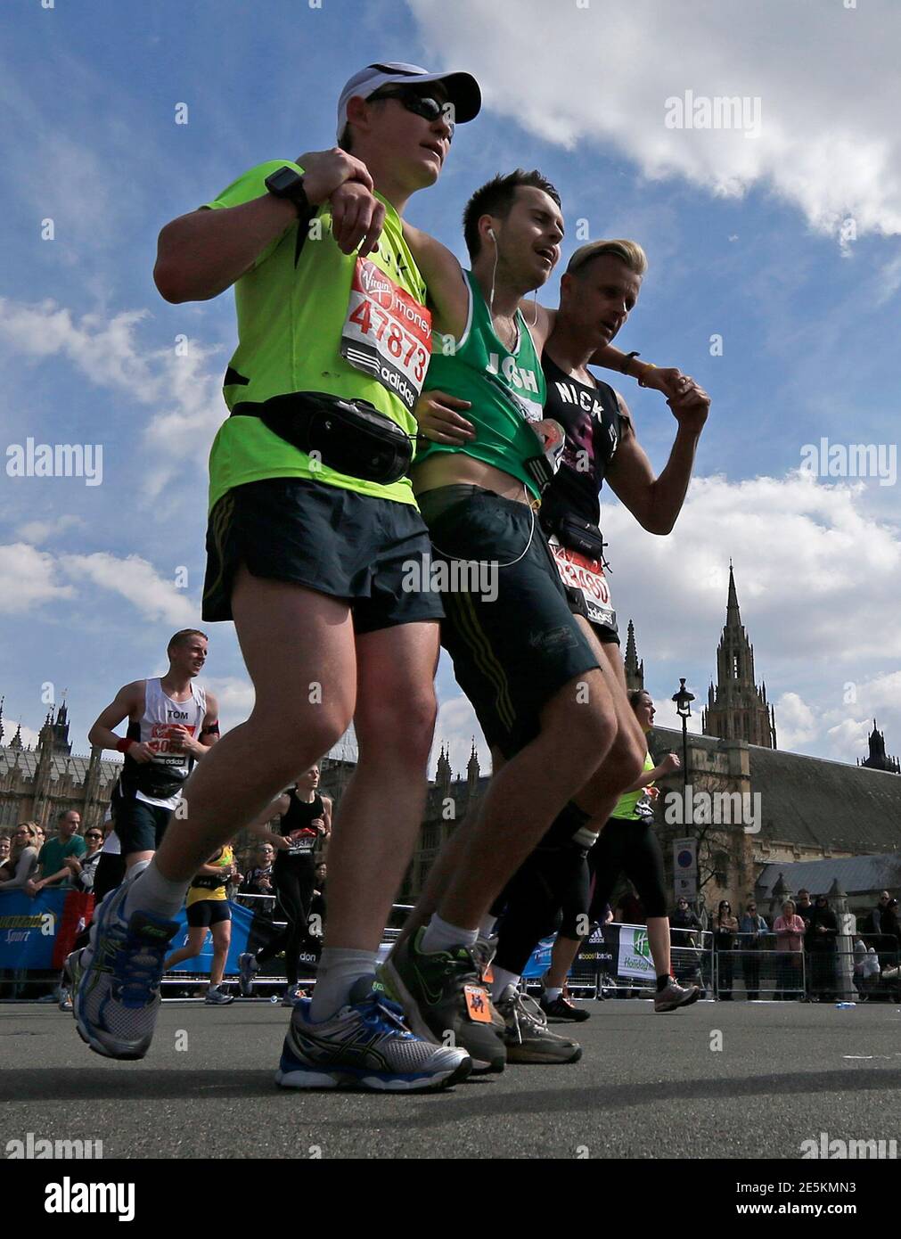 A runner is helped during the final mile in Parliament Square during the London  Marathon April 21, 2013. Undaunted by the Boston Marathon bombings, big  crowds lined the route of London 's