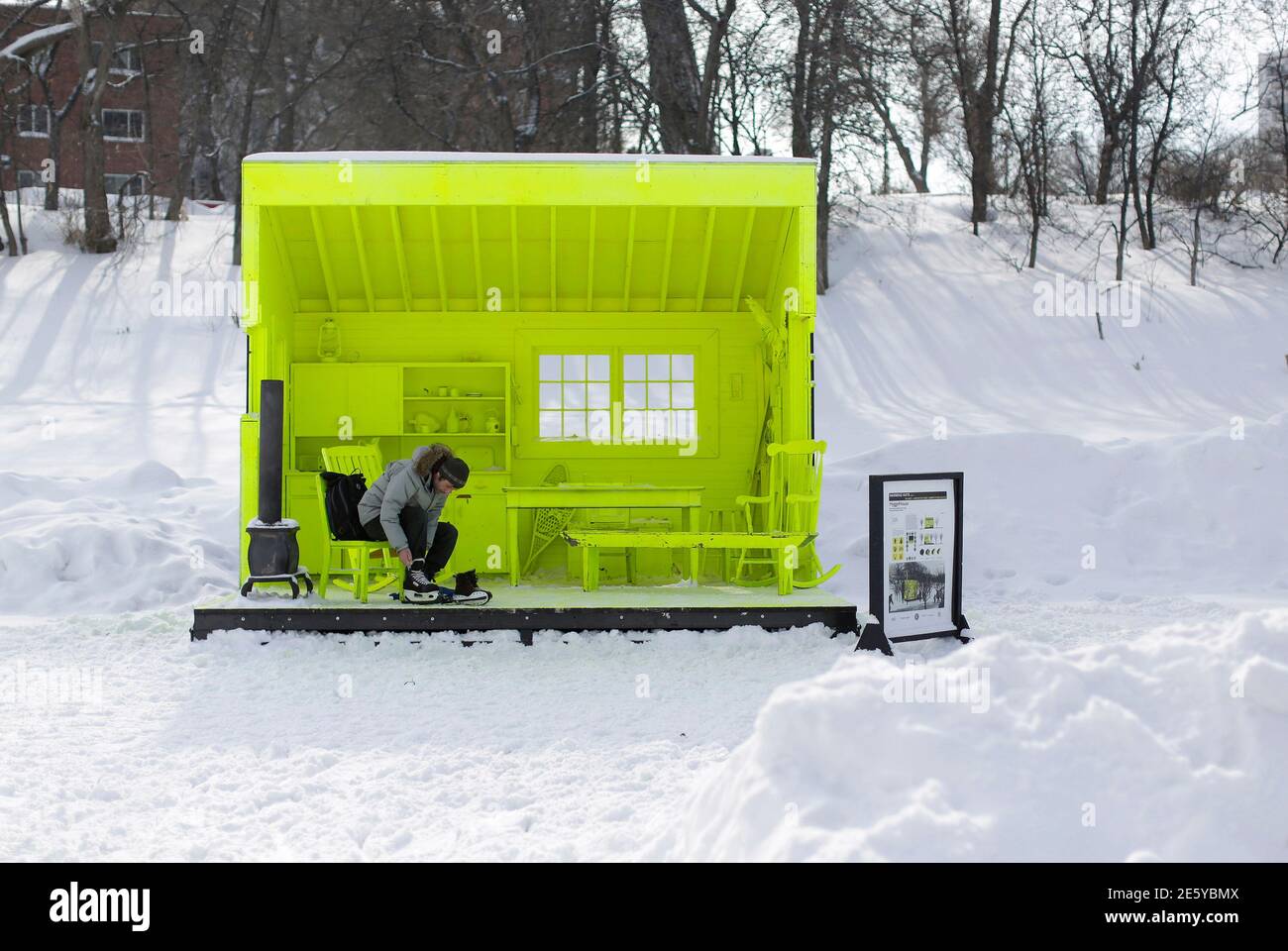 A skater ties his skates in a warming shelter along a river trail near the historic site of the Forks, the confluence of the Red and Assinibione rivers in Winnipeg, Manitoba February 17, 2014. Hundreds of people took to the rivers in warmer weather on Louis Riel day, a provincial holiday. REUTERS/Lyle Stafford (CANADA - Tags: SOCIETY ENVIRONMENT) Foto de stock