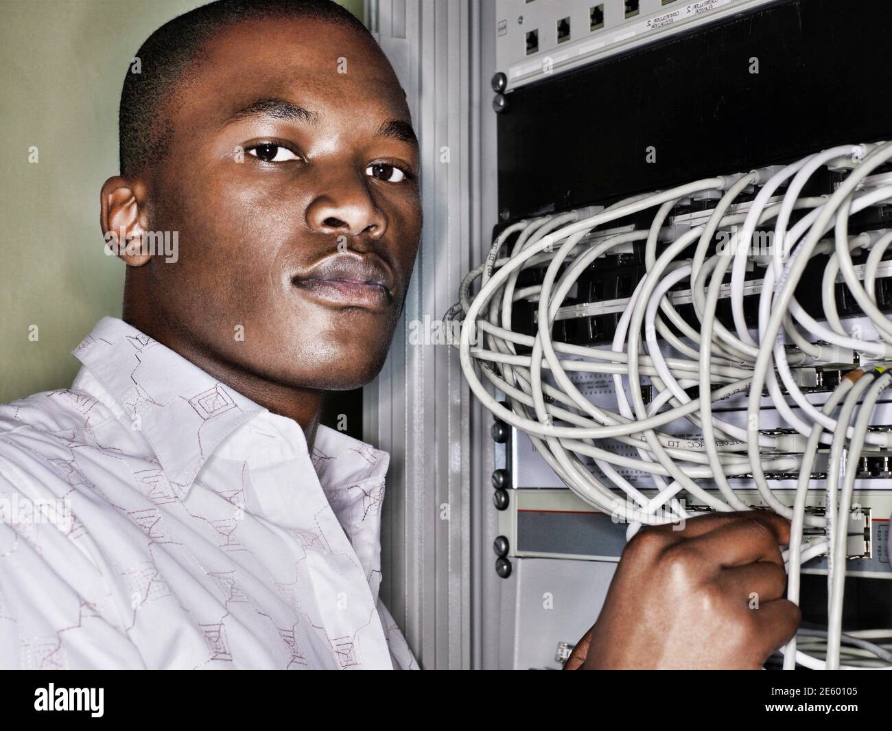 Retrato de un técnico africano que trabaja en la sala de servidores Foto de stock