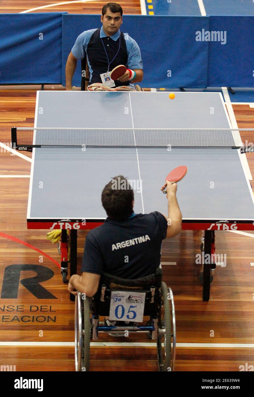 Argentina's Gabriel Copola (bottom) returns the ball to India's Trivendra  Singh during their men's singles match at the International Paralympic Copa  Costa Rica in San Jose August 11, 2010. 17 countries, members
