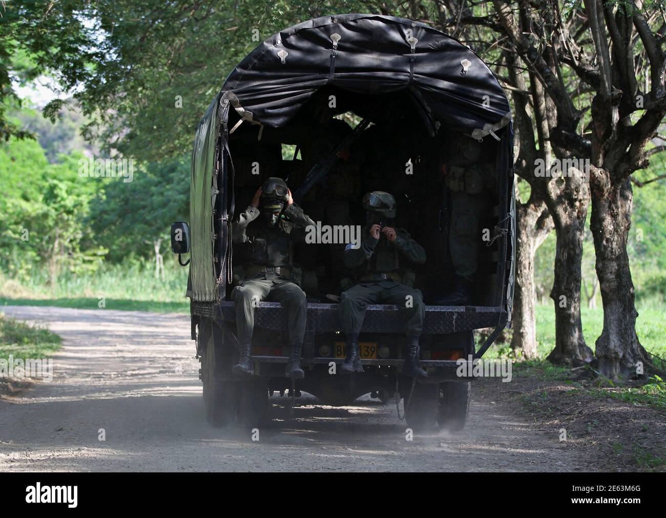 Policemen are transported by a truck before a training at the Jungla  International Course, in Chicoral near Ibague November 26, 2013. Every year  the Colombian police force invites elite law enforcement and
