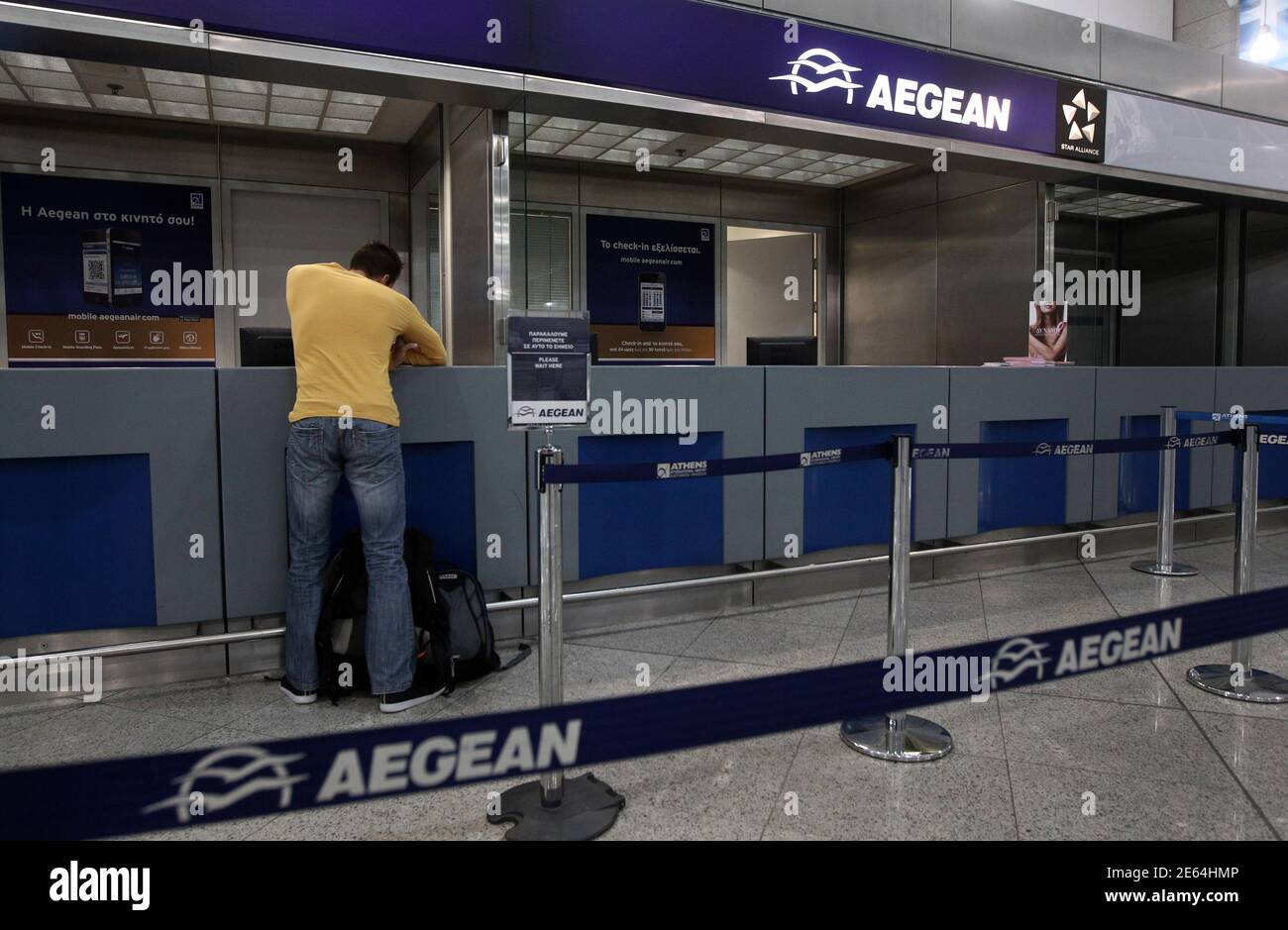 Sombreado lavar Estallar A commuter stands at an Aegean airlines ticket office inside Athens'  Eleftherios Venizelos airport October 23, 2012. Greece's Aegean Airlines is  making a fresh attempt to buy Olympic Air, this time for